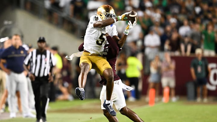 Aug 31, 2024; College Station, Texas, USA; Notre Dame Fighting Irish wide receiver Beaux Collins (5) catches a pass as Texas A&M Aggies defensive back Dashawn Fillmore (26) attempts to break up the play in the fourth quarter at Kyle Field. 