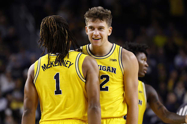 Michigan forward Will Tschetter and guard Trey McKenney celebrate during a recent game.
