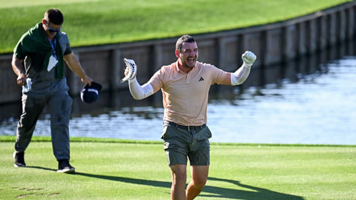 Alejandro Tosti celebrates making a hole-in-one after jumping in the water on Hole 17 at TPC Sawgrass.