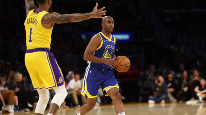 Oct 13, 2023; Los Angeles, California, USA; Golden State Warriors guard Chris Paul (3) dribbles the ball against Los Angeles Lakers guard D'Angelo Russell (1) during the first quarter at Crypto.com Arena. Mandatory Credit: Kiyoshi Mio-USA TODAY Sports