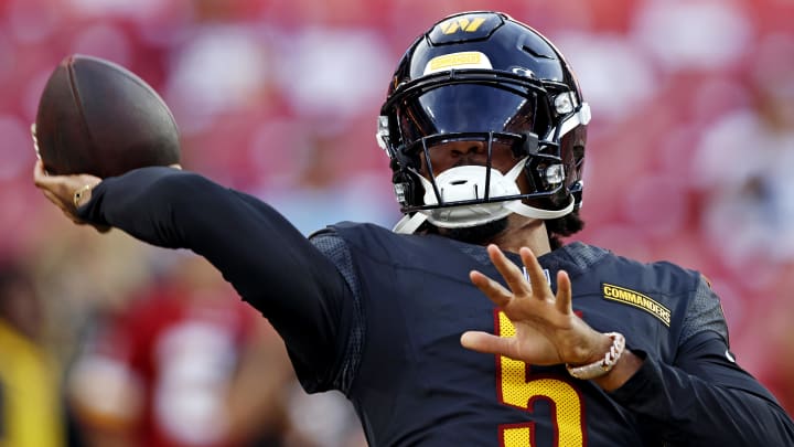 Aug 25, 2024; Landover, Maryland, USA; Washington Commanders quarterback Jayden Daniels (5) warms up before playing a preseason game against the New England Patriots at Commanders Field. Mandatory Credit: Peter Casey-USA TODAY Sports