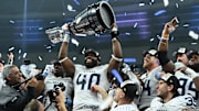 Nov 17, 2024; Vancouver, British Columbia, CAN; Toronto Argonauts defensive lineman Robbie Smith (40) holds up the Grey Cup at BC Place against Winnipeg Blue Bombers . Mandatory Credit: Simon Fearn-Imagn Images