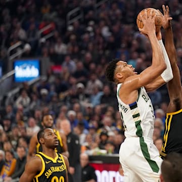 Mar 6, 2024; San Francisco, California, USA; Milwaukee Bucks forward Giannis Antetokounmpo (34) is fouled by Golden State Warriors forward Draymond Green (23) in the first quarter at the Chase Center. Mandatory Credit: Cary Edmondson-Imagn Images