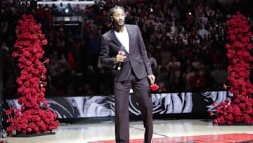 Chicago Bulls and New York Knicks former player Derrick Rose speaks as he is honored at halftime.