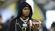 Oregon Ducks wide receiver Dakorien Moore watches teammates warm up before a game against the Minnesota Golden Gophers at Autzen Stadium.