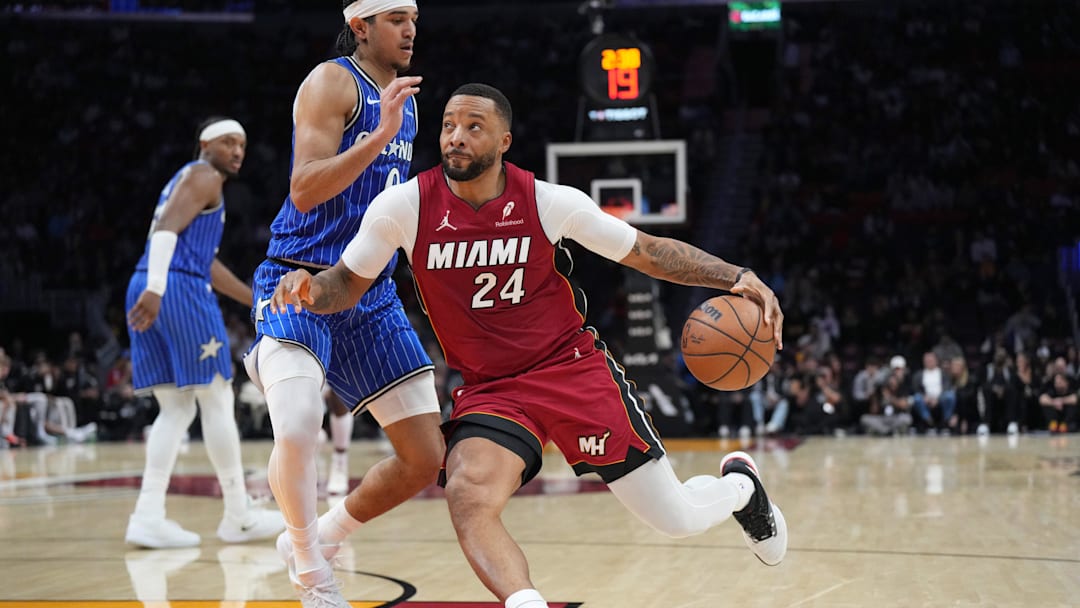 Jan 28, 2026; Miami, Florida, USA;  Miami Heat guard Norman Powell (24) drives past Orlando Magic guard Anthony Black (0) during the second half at Kaseya Center. Mandatory Credit: Jim Rassol-Imagn Images