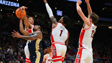 Mar 21, 2025; Seattle, WA, USA; Arizona Wildcats forward Carter Bryant (9) fouls Akron Zips guard Nate Johnson (34) during the second half in the first round of the NCAA Tournament at Climate Pledge Arena. Mandatory Credit: Steven Bisig-Imagn Images