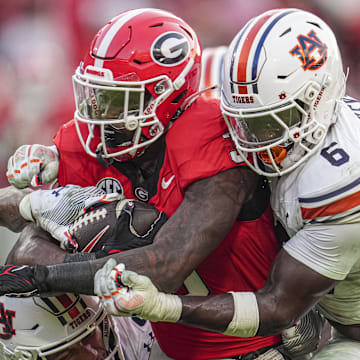 Oct 5, 2024; Athens, Georgia, USA; Georgia Bulldogs running back Nate Frazier (3) is tackled by Auburn Tigers safety Jerrin Thompson (1) and linebacker Austin Keys (6) during the second half at Sanford Stadium. Mandatory Credit: Dale Zanine-Imagn Images