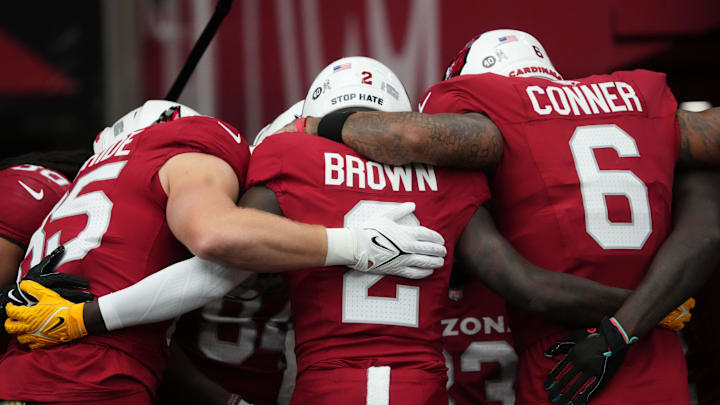 Arizona Cardinals players Trey McBride (85), Marquise Brown (2) and James Conner (6) huddle up before their game against the Atlanta Falcons at State Farm Stadium on Nov. 12, 2023, in Glendale.