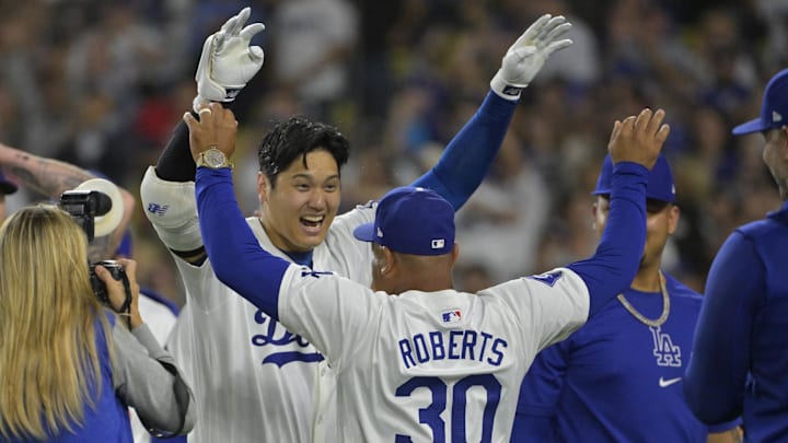  Los Angeles Dodgers designated hitter Shohei Ohtani (17) is congratulated by manager Dave Roberts.