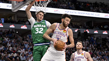 Oct 27, 2025; Dallas, Texas, USA; Oklahoma City Thunder center Chet Holmgren (7) grabs a rebound in front of Dallas Mavericks forward Cooper Flagg (32) during the second half at the American Airlines Center. Mandatory Credit: Jerome Miron-Imagn Images
