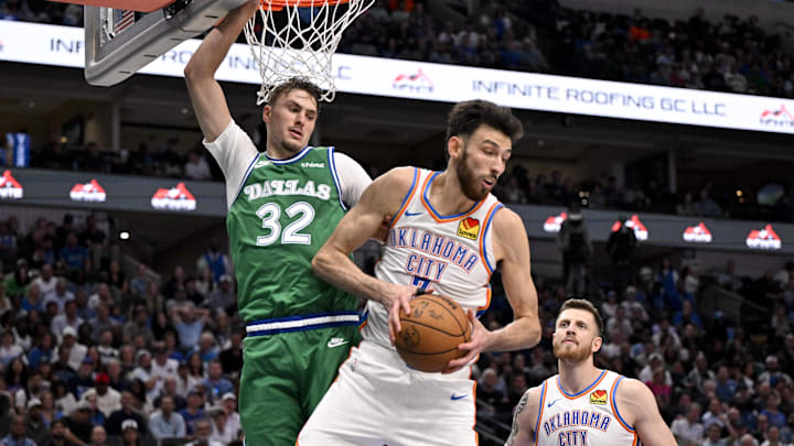 Oct 27, 2025; Dallas, Texas, USA; Oklahoma City Thunder center Chet Holmgren (7) grabs a rebound in front of Dallas Mavericks forward Cooper Flagg (32) during the second half at the American Airlines Center. Mandatory Credit: Jerome Miron-Imagn Images