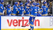 Mar 1, 2025; St. Louis, Missouri, USA;  St. Louis Blues defenseman Colton Parayko (55) is congratulated by teammates after scoring against the Los Angeles Kings during the first period at Enterprise Center. Mandatory Credit: Jeff Curry-Imagn Images