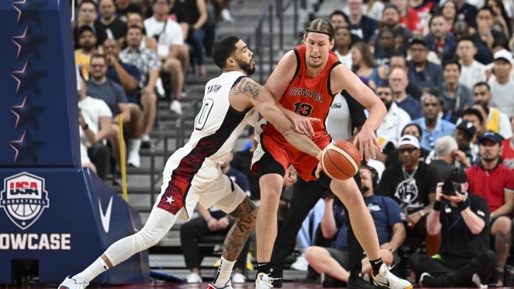 Jul 10, 2024; Las Vegas, Nevada, USA; USA forward Jayson Tatum (10) knocks the ball away from Canada forward Kelly Olynyk (13) in the first quarter during the USA Basketball Showcase at T-Mobile Arena. Mandatory Credit: Candice Ward-USA TODAY Sports