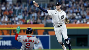  Detroit Tigers shortstop Trey Sweeney (27) makes a throw to first to complete a double play as Boston Red Sox third baseman Alex Bregman (2) slides into second in the seventh inning at Comerica Park.