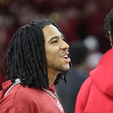 Arkansas Razorbacks guard Boogie Fland talks to forward Adou Thiero prior to the Hogs' last regular season game against the Mississippi State Bulldogs at Bud Walton Arena on March 8. Arkansas is 9-6 since Fland was injured.