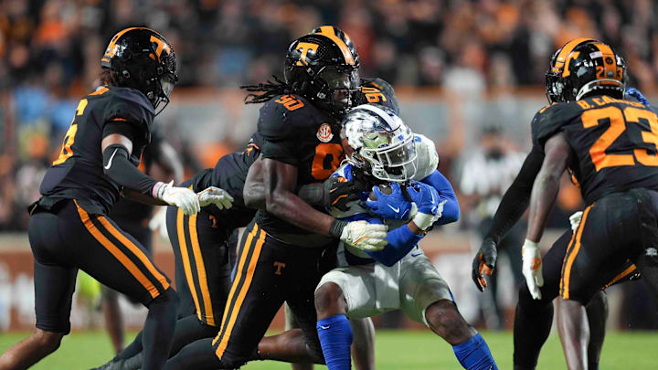 Nov 2, 2024; Knoxville, Tennessee, USA; Tennessee Volunteers defensive lineman Dominic Bailey (90) tackles Kentucky Wildcats during the second half at Neyland Stadium. Mandatory Credit: Caitie McMekin/USA TODAY Network via Imagn Images