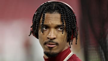 Jan 12, 2025; Tampa, Florida, USA; Washington Commanders quarterback Jayden Daniels (5) warms up before a NFC wild card playoff against the Tampa Bay Buccaneers at Raymond James Stadium. Mandatory Credit: Nathan Ray Seebeck-Imagn Images