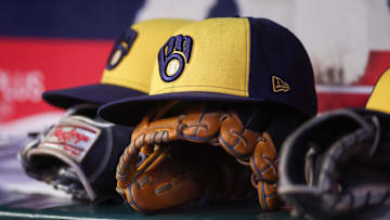 Aug 4, 2025; Atlanta, Georgia, USA; A detailed view of a Milwaukee Brewers hat and glove in the dugout against the Atlanta Braves in the fourth inning at Truist Park. Mandatory Credit: Brett Davis-Imagn Images