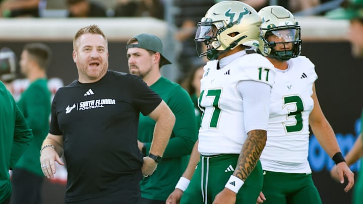 Oct 10, 2025; Denton, Texas, USA; South Florida Bulls head coach Alex Golesh and quarterback Byrum Brown (17) talk prior to a game against the North Texas Mean Green at DATCU Stadium. Mandatory Credit: Raymond Carlin III-Imagn Images