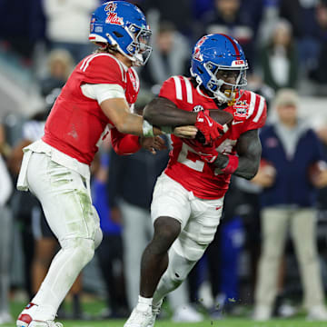 Jan 2, 2025; Jacksonville, FL, USA; Mississippi Rebels quarterback Jaxson Dart (2) hands off to running back Ulysses Bentley IV (24) against the Duke Blue Devils in the second quarter  during the Gator Bowl at EverBank Stadium. Mandatory Credit: Nathan Ray Seebeck-Imagn Images