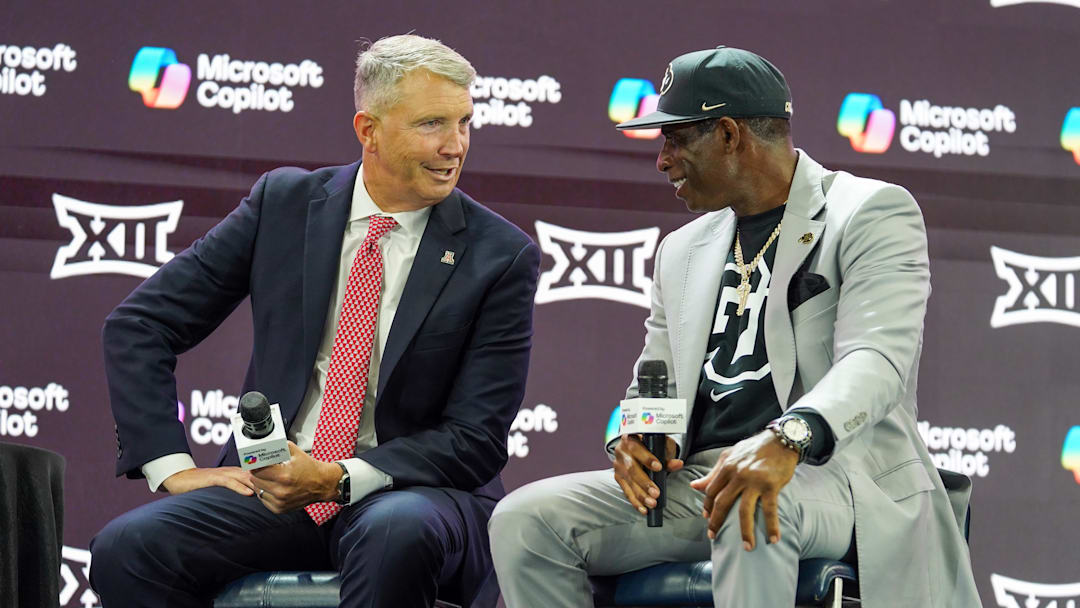 Jul 9, 2025; Frisco, TX, USA; Arizona head coach Brent Brennan and Colorado head coach Deion Sanders talk on stage during 2025 Big 12 Football Media Days at The Star. 