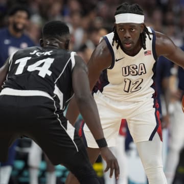 Jul 31, 2024; Villeneuve-d'Ascq, France; United States guard Jrue Holiday (12) dribbles against South Sudan shooting guard Peter Jok (14) in the fourth quarter during the Paris 2024 Olympic Summer Games at Stade Pierre-Mauroy. Mandatory Credit: John David Mercer-USA TODAY Sports