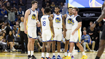 Oct 8, 2025; San Francisco, California, USA;  Golden State Warriors guard Taevion Kinsey (77) huddles with guard LJ Cryer (18), center Quinten Post (21), guard Will Richard (3), and guard Pat Spencer (61) during the fourth quarter against the Portland Trail Blazers at Chase Center. Mandatory Credit: John Hefti-Imagn Images