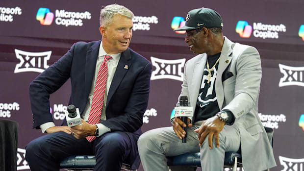 Arizona head coach Brent Brennan and Colorado head coach Deion Sanders talk on stage during 2025 Big 12 Football Media Days a