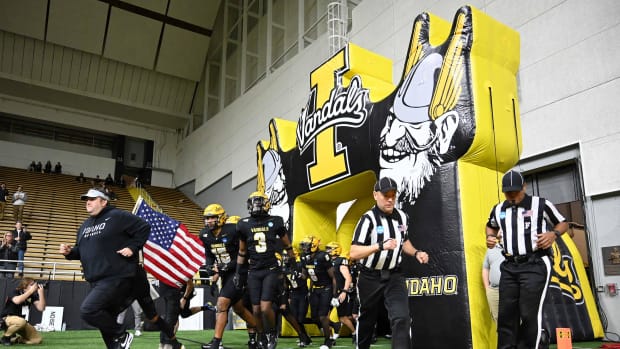 Idaho Vandals head coach Jason Eck (first from left) leads his team onto he field before a game against the Southern Illinois