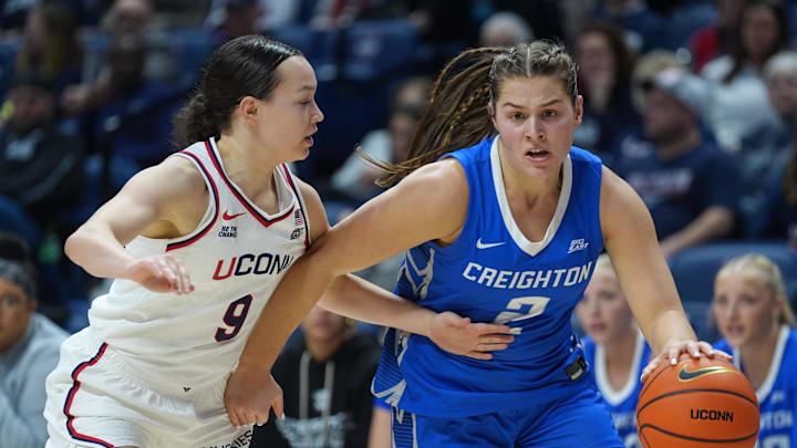 Creighton Bluejays guard Kennedy Townsend drives the ball against UConn Huskies guard Kayleigh Heckel