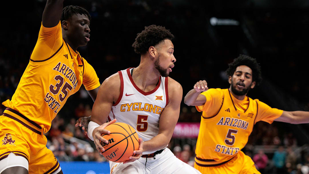 Mar 11, 2026; Kansas City, MO, USA; Iowa State Cyclones forward Joshua Jefferson (5) protects the ball from Arizona State Sun Devils center Massamba Diop (35) during the first half at T-Mobile Center. Mandatory Credit: William Purnell-Imagn Images