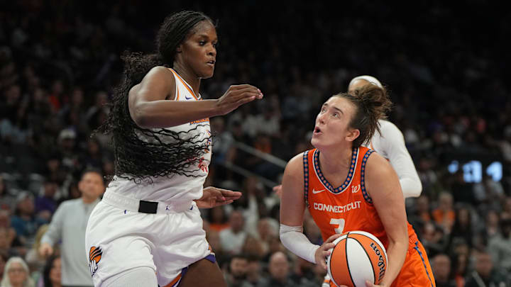 Aug 5, 2025; Phoenix, Arizona, USA; Connecticut Sun guard Marina Mabrey (3) drives on Phoenix Mercury center Kalani Brown (21) in the second half at Footprint Center. Mandatory Credit: Rick Scuteri-Imagn Images