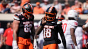 Oklahoma State Cowboys quarterback Sam Jackson V (18) walks off after the offense was stopped on a third down a college football game between the Oklahoma State Cowboys (OSU) and the Houston Cougars at Boone Pickens Stadium in Stillwater, Okla., Saturday, Oct. 11, 2025. Houston won 39-17.