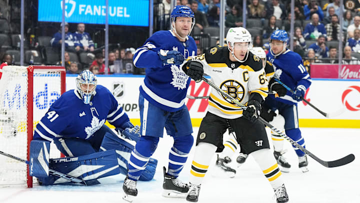 Nov 5, 2024; Toronto, Ontario, CAN; Boston Bruins left wing Brad Marchand (63) battles with Toronto Maple Leafs defenseman Morgan Rielly (44) in front of goaltender Anthony Stolarz (41) during the second period at Scotiabank Arena. Mandatory Credit: Nick Turchiaro-Imagn Imagess