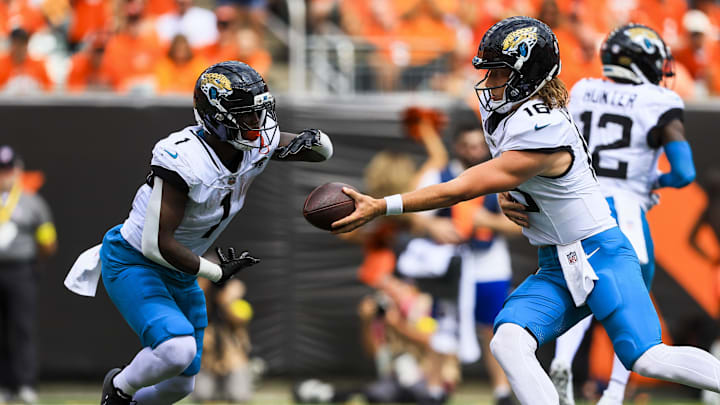 Sep 14, 2025; Cincinnati, Ohio, USA; Jacksonville Jaguars quarterback Trevor Lawrence (16) hands the ball off to running back Travis Etienne Jr. (1) in the first half against the Cincinnati Bengals at Paycor Stadium. Mandatory Credit: Katie Stratman-Imagn Images