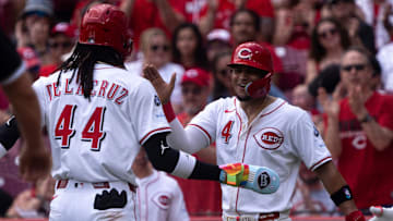 Cincinnati Reds shortstop Elly De La Cruz (44) and Cincinnati Reds second baseman Santiago Espinal (4) greet each other at home plate after scoring on a Cincinnati Reds outfielder Will Benson (30) base hit in the first inning of the MLB game between Cincinnati Reds and Chicago White Sox at Great American Ball Park in Cincinnati on Thursday, May 15, 2025.