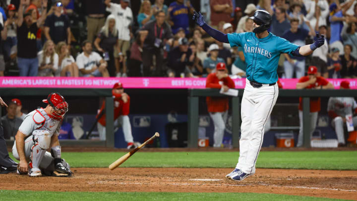 Seattle Mariners right fielder Mitch Haniger (right) celebrates after drawing a walk-off walk against the Philadelphia Phillies on Saturday at T-Mobile Park.