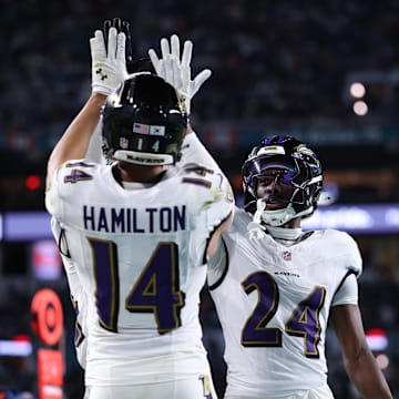 Oct 30, 2025; Miami Gardens, Florida, USA;  Baltimore Ravens safety Kyle Hamilton (14) and safety Malaki Starks (24) react after a play during the second quarter against the Miami Dolphins at Hard Rock Stadium. Mandatory Credit: Nathan Ray Seebeck-Imagn Images