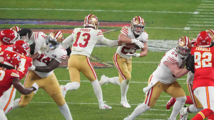 Feb 11, 2024; Paradise, Nevada, USA;  San Francisco 49ers quarterback Brock Purdy (13) hands the ball to running back Christian McCaffrey (23) against the Kansas City Chiefs during overtime of Super Bowl LVIII at Allegiant Stadium. Mandatory Credit: Joe Camporeale-USA TODAY Sports