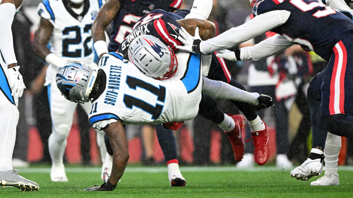 Aug 8, 2024; Foxborough, Massachusetts, USA; New England Patriots linebacker Oshane Ximines (93) tackles Carolina Panthers wide receiver Ihmir Smith-Marsette (11) during the first half at Gillette Stadium. 