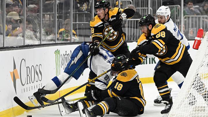 Mar 15, 2025; Boston, Massachusetts, USA; Boston Bruins center Morgan Geekie (39), right wing David Pastrnak (88) and center Pavel Zacha (18) battle over Tampa Bay Lightning defenseman Erik Cernak (81) for the puck during the third period at TD Garden. Mandatory Credit: Eric Canha-Imagn Images