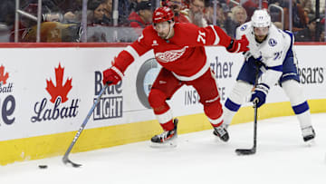 Feb 8, 2025; Detroit, Michigan, USA;  Detroit Red Wings center Dylan Larkin (71) skates with the puck chased by Tampa Bay Lightning defenseman Victor Hedman (77) in the second period at Little Caesars Arena. Mandatory Credit: Rick Osentoski-Imagn Images