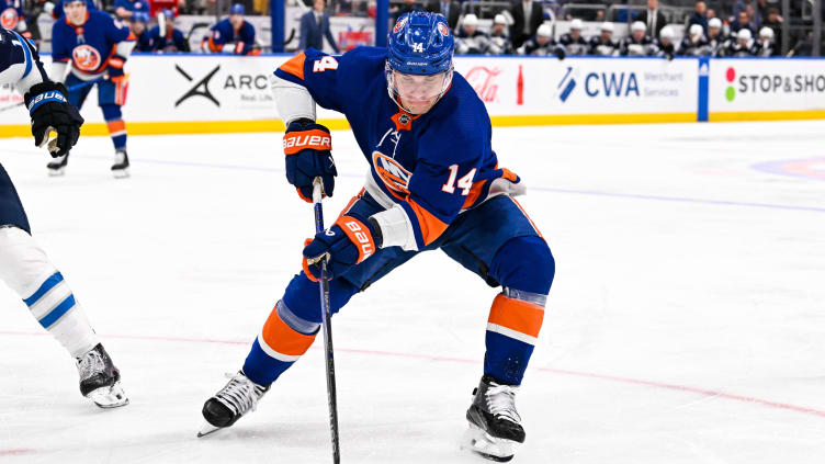 Mar 23, 2024; Elmont, New York, USA;  New York Islanders center Bo Horvat (14) controls the puck against the Winnipeg Jets during the second period at UBS Arena. Mandatory Credit: Dennis Schneidler-USA TODAY Sports