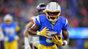 Los Angeles Chargers wide receiver Joshua Palmer (5) runs the ball against the Denver Broncos during the first half at SoFi Stadium. 