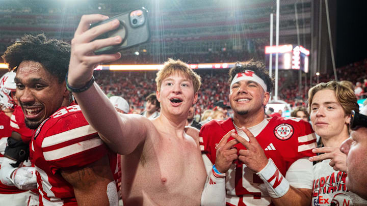 Nov 23, 2024; Lincoln, Nebraska, USA; Nebraska Cornhuskers quarterback Dylan Raiola (15) takes a picture with fans after defeating the Wisconsin Badgers at Memorial Stadium. Nov 23, 2024; Lincoln, Nebraska, USA; Nebraska Cornhuskers quarterback Dylan Raiola (15) takes a picture with fans after defeating the Wisconsin Badgers at Memorial Stadium.