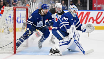 Jan 16, 2025; Toronto, Ontario, CAN;  Toronto Maple Leafs goalie Joseph Woll (60) and defenseman Chris Tanev (8) defend their goal against New Jersey Devils forward Nathan Bastian (14) in the second period at Scotiabank Arena. Mandatory Credit: Dan Hamilton-Imagn Images