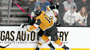 Mar 20, 2025; Las Vegas, Nevada, USA; Vegas Golden Knights defenseman Nicolas Hague (14) checks Boston Bruins center Jakub Lauko (94) during the third period at T-Mobile Arena. Mandatory Credit: Stephen R. Sylvanie-Imagn Images