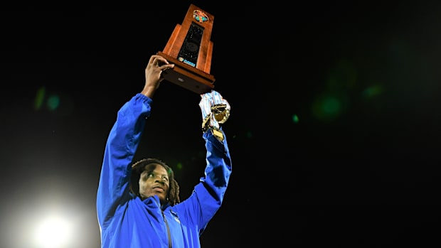Miami Northwestern's Teddy Bridgewater raises the state trophy following the team's win over Raines in the Class 3A champions