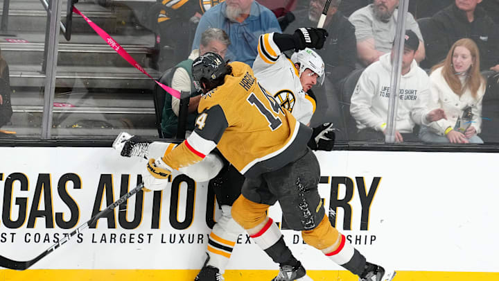 Mar 20, 2025; Las Vegas, Nevada, USA; Vegas Golden Knights defenseman Nicolas Hague (14) checks Boston Bruins center Jakub Lauko (94) during the third period at T-Mobile Arena. Mandatory Credit: Stephen R. Sylvanie-Imagn Images